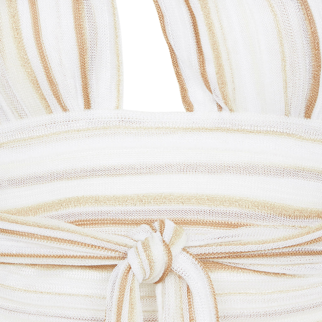 Close-up of a beige and white striped fabric with a knot detail.