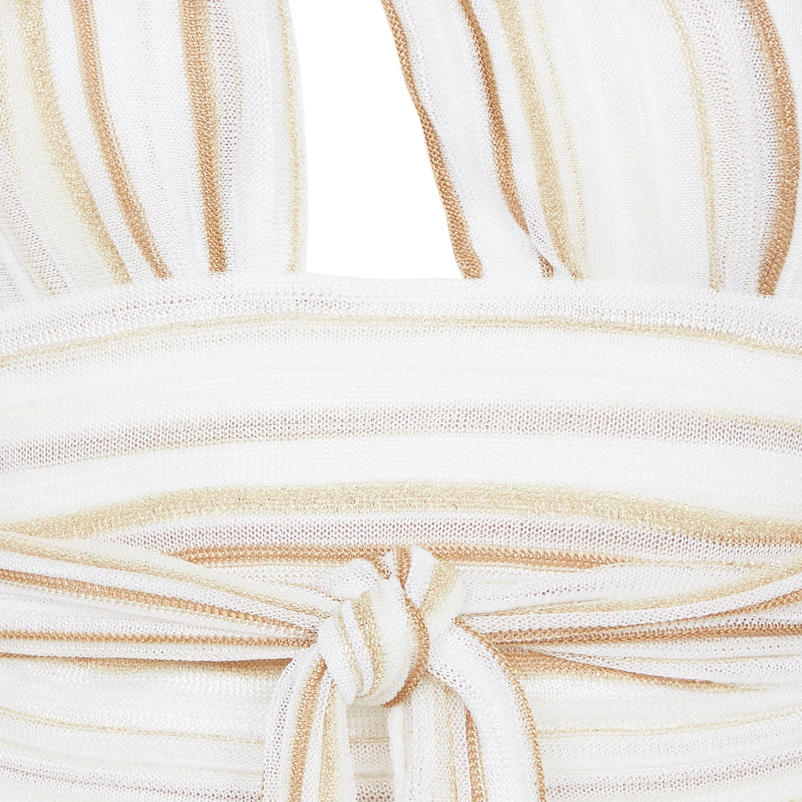 Close-up of a beige and white striped fabric with a knot detail.
