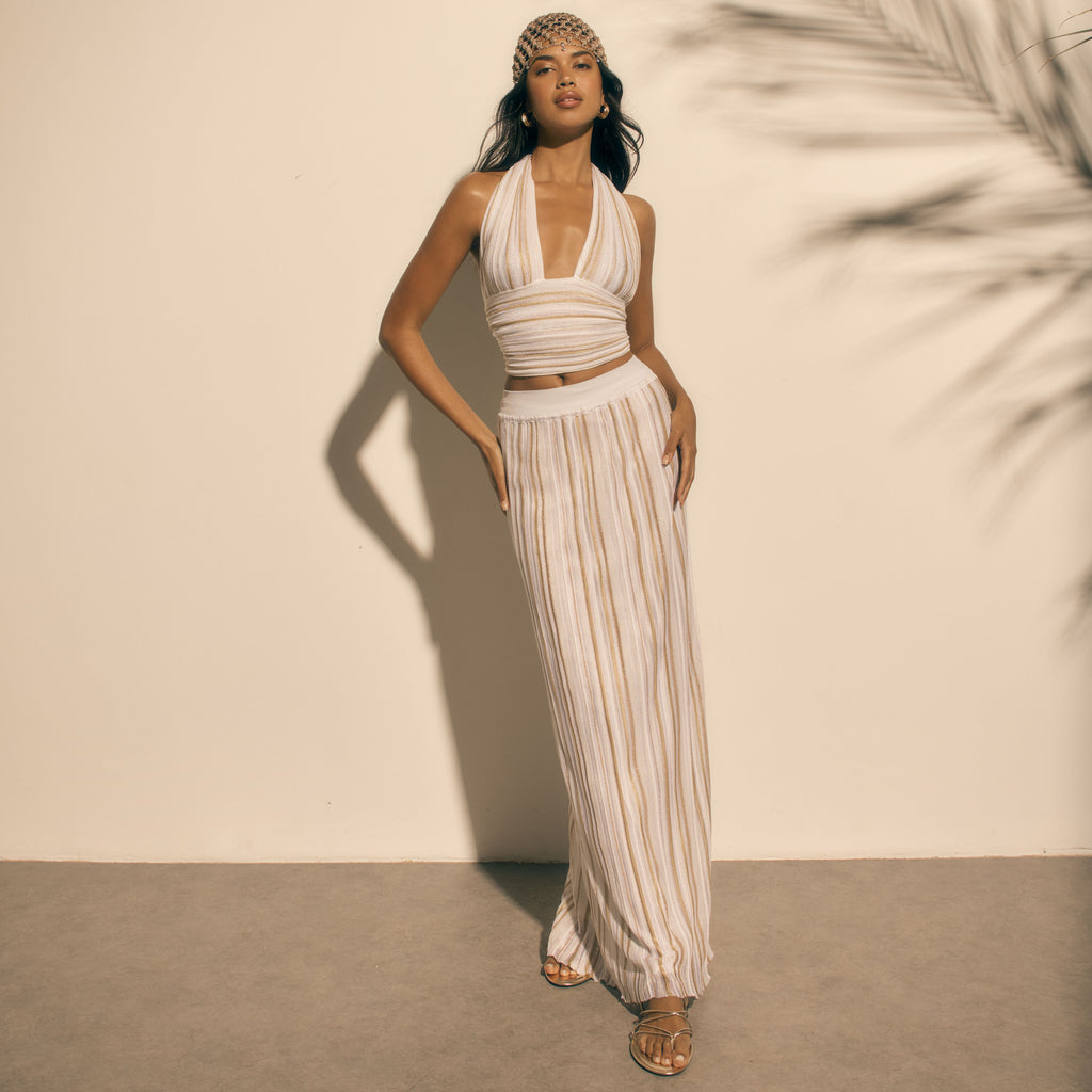 model wearing white gold lurex knit halter top and maxi skirt kukhareva london
