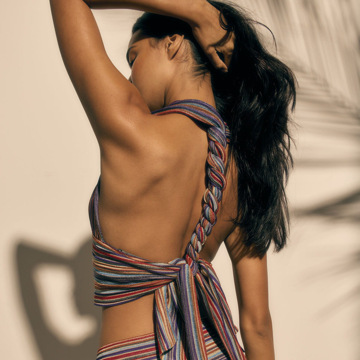 Model wearing a colorful striped top back view with racer back against a beige background Bella Top Berry Fig by Kukhareva London