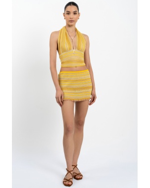 Model wearing Bella Halterneck Top in Sunshine styled as a one-shoulder top
